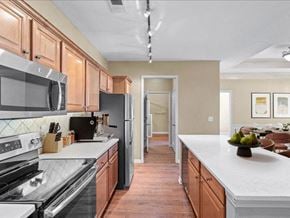 Olathe apartment for rent - A kitchen with stainless steel appliances at Avignon Apartment Homes, Olathe
