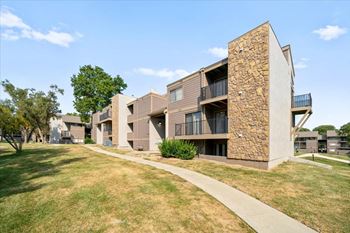 Modern apartment building with a stone facade and balconies