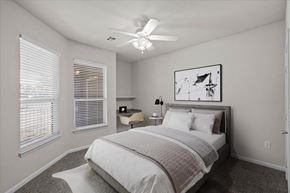 Olathe apartment for rent - A bedroom with a bed, nightstand, and a ceiling fan. at Somerset Oaks Apartment Homes, Olathe, KS, 66062
