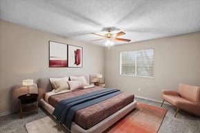 Overland Park apartment for rent - A bedroom with a ceiling fan and window. at Preston Court Apartment Homes, Overland Park, Kansas