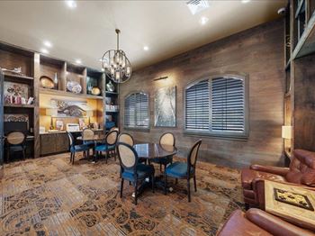 A dining room with a table and chairs