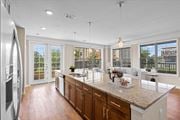 Kansas City apartment for rent - a kitchen with a large island next to a living room at The Dorset, Kansas City, MO