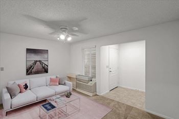 A living room with a white couch and a ceiling fan