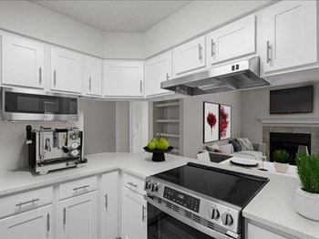 A white kitchen with a stove and a microwave