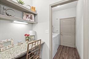 Overland Park apartment for rent - a dining room with a table and chairs and a laundry room in the background at Stonepost Crossing Apartments, Kansas, 66213