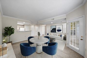 Overland Park apartment for rent - A white and blue living room with a round table and chairs.
