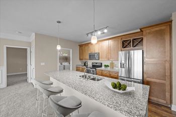 A kitchen with a counter top and a stainless steel refrigerator