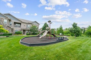 A playground with a slide and a basketball hoop.
