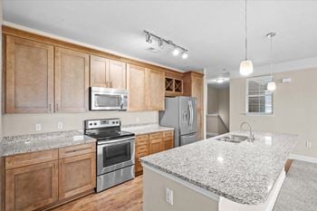 A kitchen with granite counter tops and stainless steel appliances
