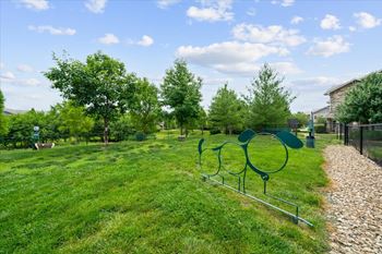 A green park with a sculpture of three circles.