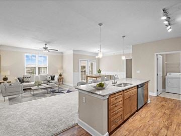 Overland Park apartment for rent - a kitchen with an island and a living room with a couch