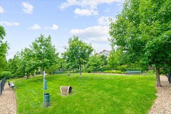 A park with a green lawn and trees.