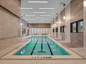Overland Park apartment for rent - a swimming pool in the middle of a large room with tile flooring and walls
