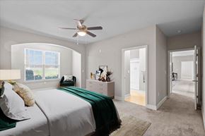 Lenexa townhouse for rent - a bedroom with a bed and a ceiling fan at Prairie Creek Apartments & Townhomes Apartments, Lenexa 66219