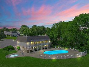 Overland Park townhouse for rent - A house with a pool in the backyard at Sheridan Ridge Townhomes Apartments, Overland Park, KS, 66212