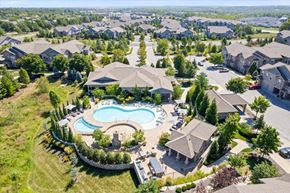 Overland Park apartment for rent - an aerial view of a house with a pool in the yard at Stonepost Crossing Apartments, Overland Park, KS, 66213