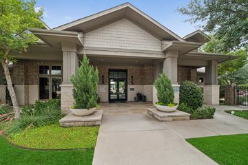 Lewisville apartment for rent - A building with a front yard and a walkway leading to the entrance.