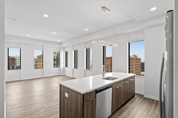 A modern kitchen with wooden cabinets and a large island.