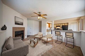 Olathe apartment for rent - A living room with a fireplace and a grey couch.