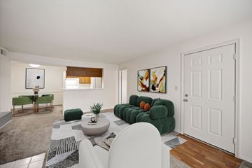 Overland Park apartment for rent - A living room with a white couch and a green sofa.