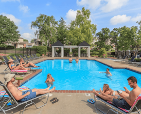 Overland Park apartment for rent - People are relaxing by the pool on a sunny day.