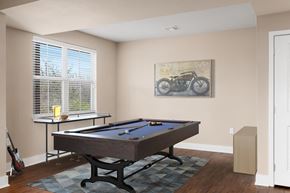 Lenexa townhouse for rent - a game room with a pool table and a bike on the wall at Prairie Creek Apartments & Townhomes Apartments, Lenexa, KS, 66219