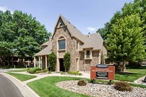 Overland Park apartment for rent - A stone house with a sign in front that says