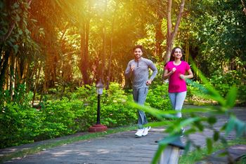 A couple jogging in a park