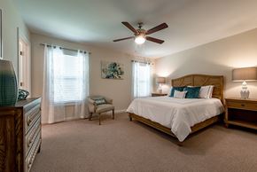 Bluffton apartment for rent - A bedroom with a large bed and a ceiling fan.