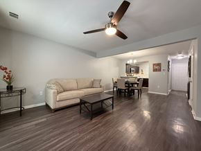 Rock Hill apartment for rent - A living room with a beige couch, a coffee table, and a ceiling fan.
