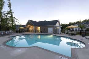 Raleigh apartment for rent - A large swimming pool in front of a house.