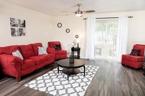 Raleigh townhouse for rent - A living room with red couches and a black coffee table.