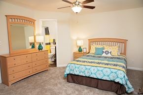 Raleigh townhouse for rent - A bedroom with a bed, dresser, and mirror.