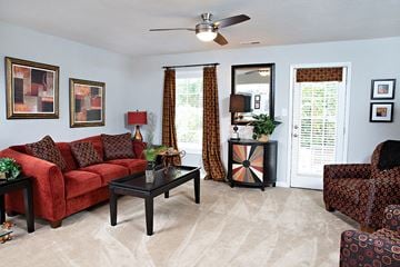Asheville apartment for rent - a living room with a red couch and a coffee table
