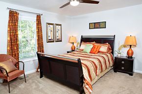 Asheville apartment for rent - a bedroom with a bed and a ceiling fan