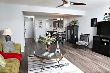 Mooresville apartment for rent - A living room with a glass table and a yellow couch.