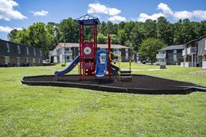 Durham apartment for rent - A playground with a red and blue slide and a blue and yellow structure.