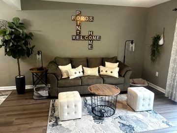 Savannah apartment for rent - A living room with a brown couch and a rug.