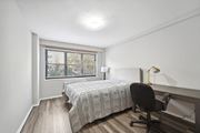 Washington apartment for rent - a bedroom with a bed and a desk and a window