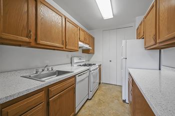 Galley style kitchen with walls of cabinets