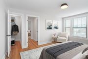 Washington apartment for rent - A bedroom with a large bed and a painting on the wall.