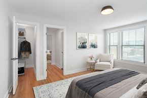 Washington apartment for rent - A bedroom with a large bed and a painting on the wall.