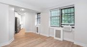 Washington apartment for rent - a living room and kitchen with white walls and wood floors
