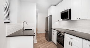 Washington apartment for rent - a kitchen with white cabinets and stainless steel appliances