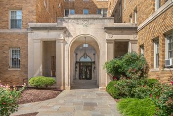 Front entry with original limestone loggia with fluted pilasters and curved archways