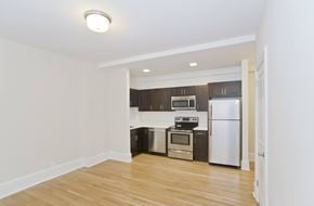 Washington apartment for rent - A kitchen with a white fridge and stove top oven.