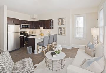 Washington apartment for rent - a living room and kitchen with a white couch and a table