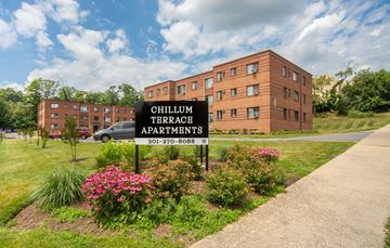 Hyattsville apartment for rent - A sign for Chillum Terrace Apartments stands in front of a brick building.
