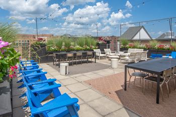 Rooftop deck with outdoor lounge nooks and lush landscaping