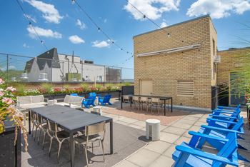 Rooftop dining space with string lights